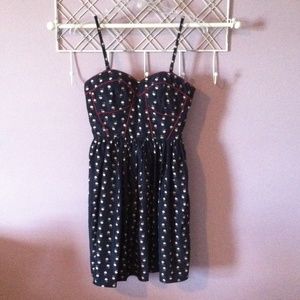 A short navy print dress with red piping.