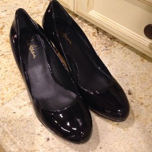 Round toe Cole Haan black patent Nike Air pumps.