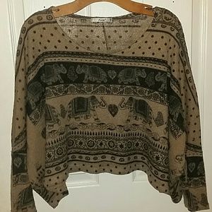 Cute elephant print tan crop top with fitted arms.