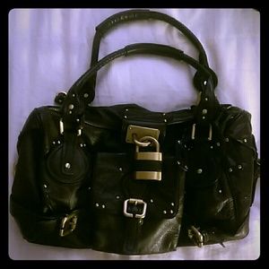 Brown purse with large lock.