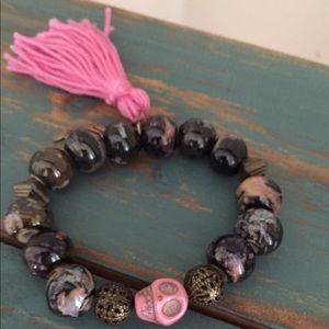 Skull bracelet, gold accents, tassel & feather