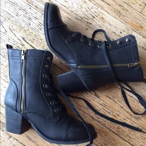 Black combat boots with old gold hardware.