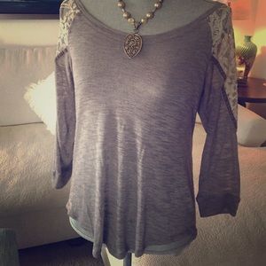 Gray jersey knit top with lace sleeve detail.