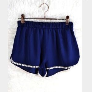 navy blue pompom flowy shorts