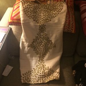 Tightly stitched bandage dress with gold detail.