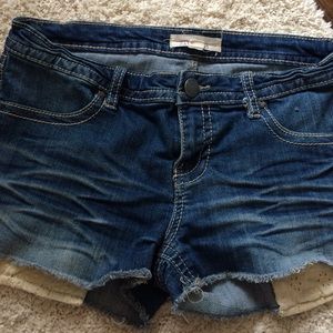 Denim shorts with lace pockets that show slightly