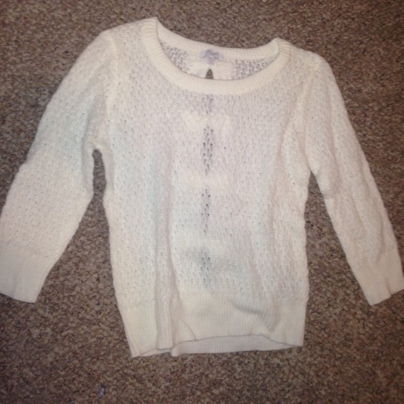 A white sweater with bows in the back