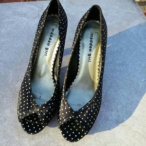 Madden girl high heels shoes with red trim sides.