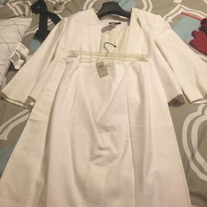 White suit never worn.   Still has tags in suit