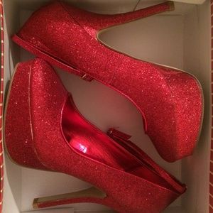Katy red sparkle platform heels.