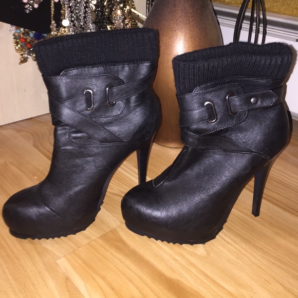 Black leather platform boots with buckle accents