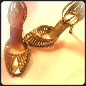 Gold sequins ankle strap peep toe heels.