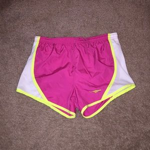 Neon yellow, pink and white running shorts.