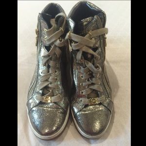 Michael Kors Gold high top sneakers.