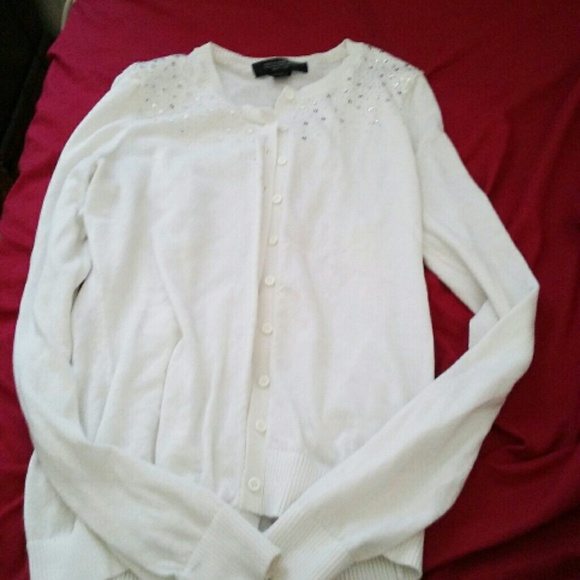 White cardigan with sliver sequins on shoulders.