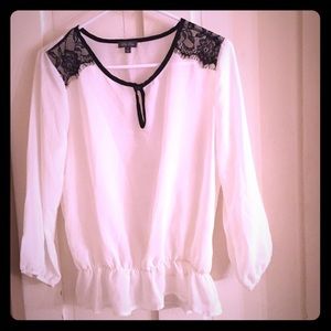 Sheer top with black lace detail.