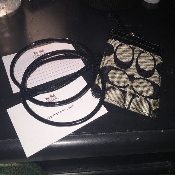 Coach id and card holder with lanyard.
