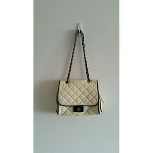 White quilt with black trim shoulder bag