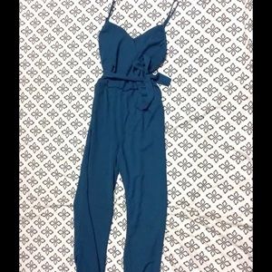 Turquoise jumpsuit fits size small and medium