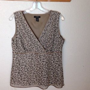 A printed mocha colored sleeveless blouse