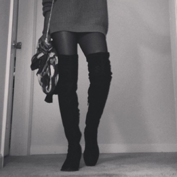 Black suede thigh high boots.
