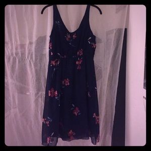 Chiffon navy dress with floral accents.