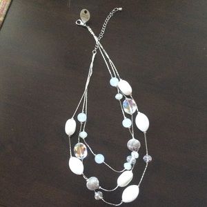 Triple strand silver and white necklace.