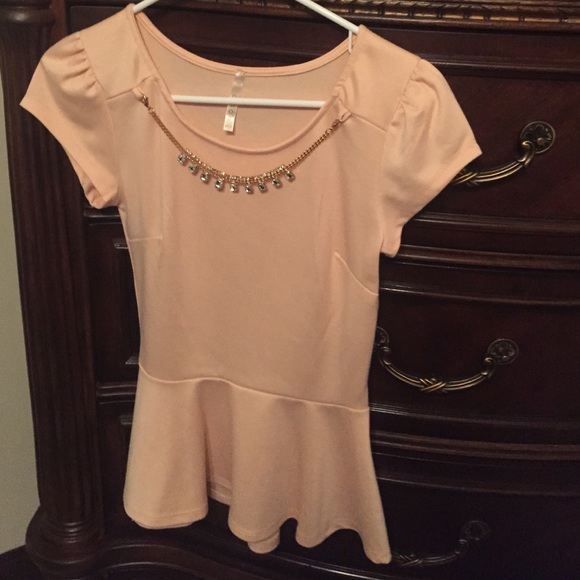 Light peach/pink peplum top.