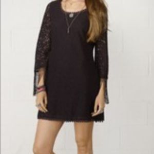 Black lace dress with fringe detail in the sleeves
