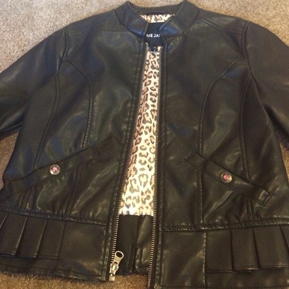 The kids a black leather jacket.