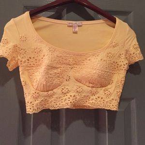 Yellow lace crop top with formed breasts