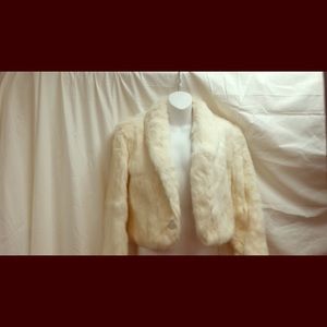 Genuine white fur coat tags still attached