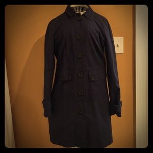 Navy blue trench coat with floral inlay.