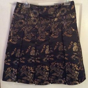 Pleated black skirt with gold embroidery skirt.