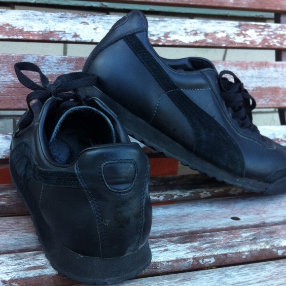 Black on black Puma running shoes