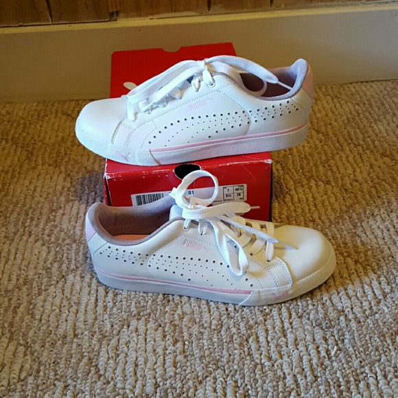 White PUMA gym shoes with pink trim.