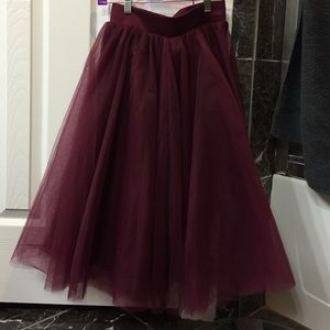 Maroon tulle knee length skirt.