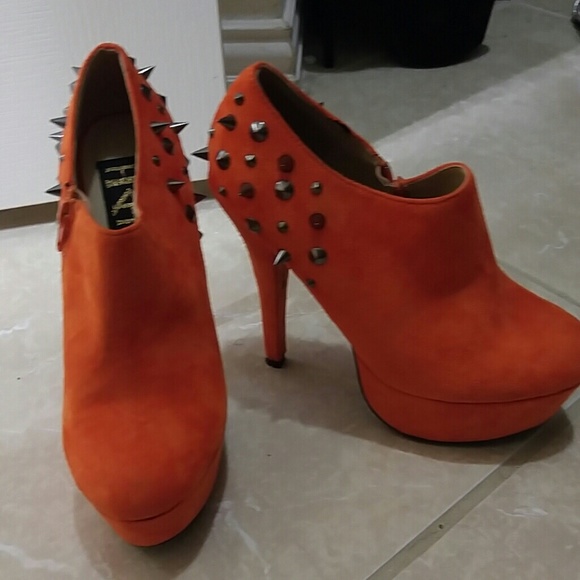Orange spike heels