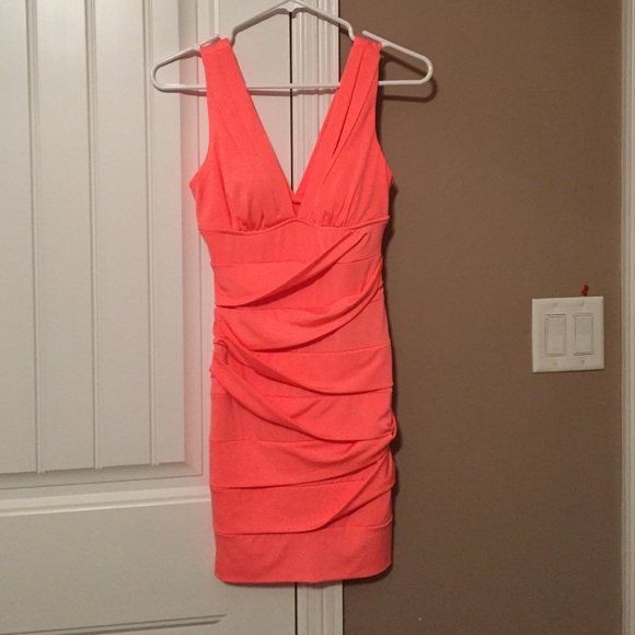 Plunging neckline, fitted melon dress.