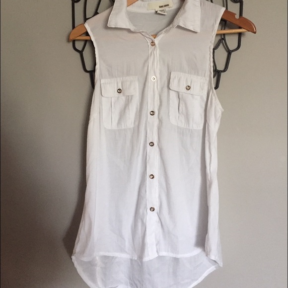 White sleeveless blouse. Gold button detail.