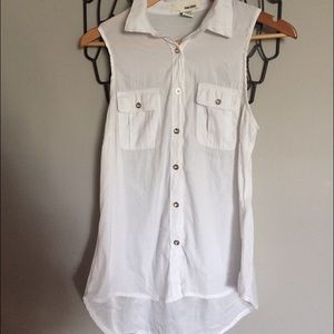 White sleeveless blouse. Gold button detail.