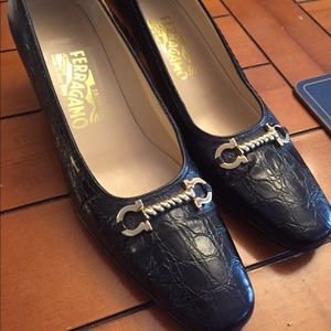 Ferragamo black horsebit lizard leather pumps.