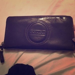 Brown, patent leather Coach wallet.