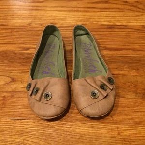 Light brown flats with button detail