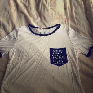 A white New York City crop top shirt.