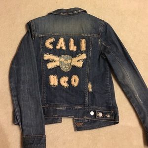 Denim jacket with skull art stitched in back