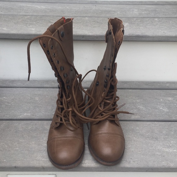 Brown lace up combat boots.