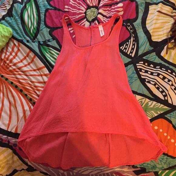 Pink top with no sleeves.