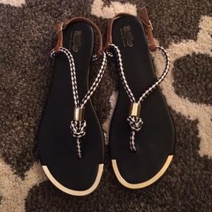 Black and gold flip flops. Previously loved.