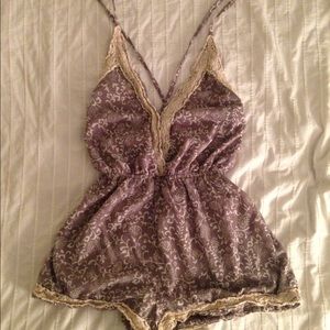 Gray romper with lace and white floral designs.